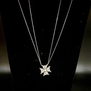 Gorgeous sterling silver cross pendant with cubic zirconia stones.